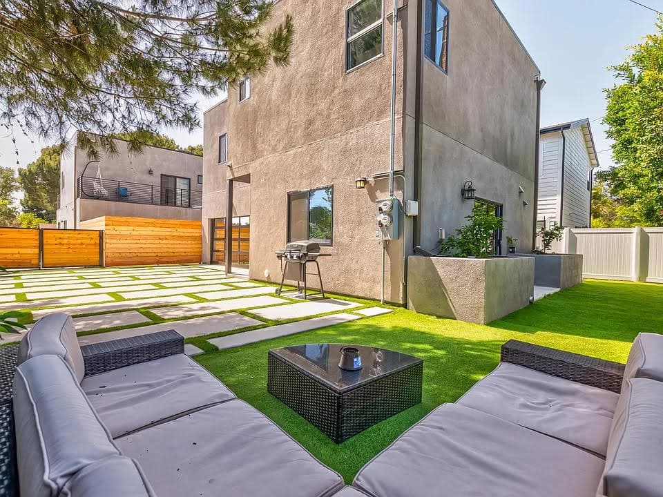 Backyard lounge area with green lawn